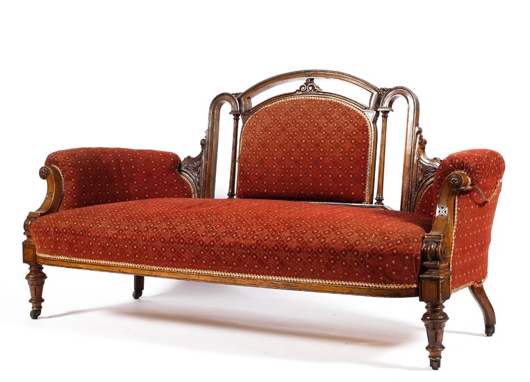 A Victorian walnut framed upholstered sofa