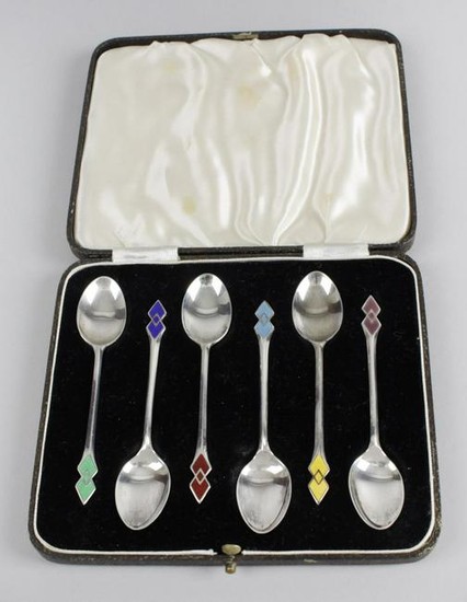 A cased set of six silver coffee spoons with harlequin