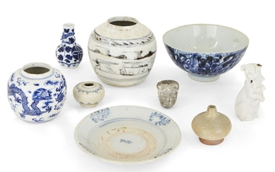 A collection of Chinese and Annamese ceramics, 15th - 19th century, comprising a lobed jarlet, 6cm diameter, two blue and white jars, 9 and 12cm high, a bowl, 17cm diameter, a white glazed figure of a dog, a celadon jarlet, a grey pottery head, and...