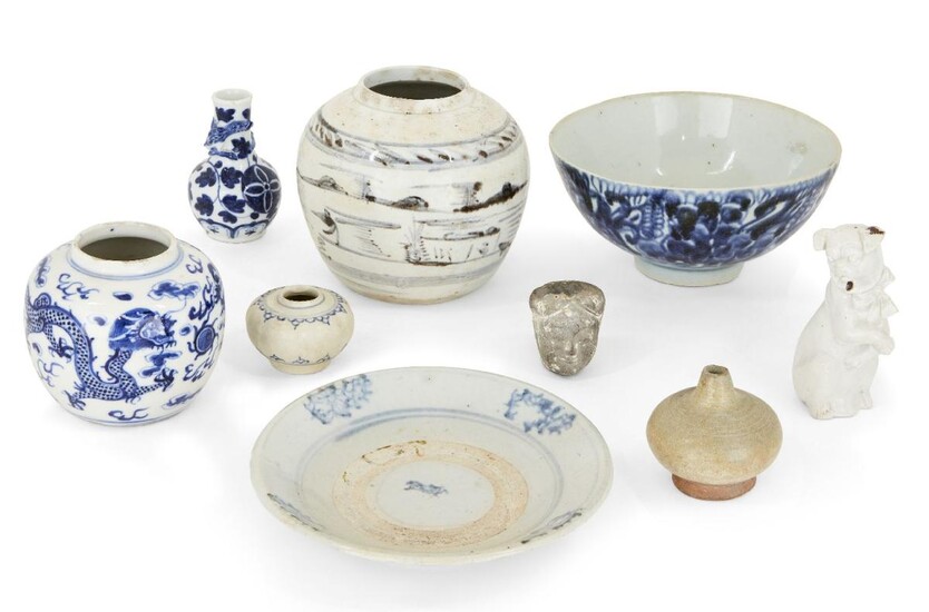 A collection of Chinese and Annamese ceramics, 15th - 19th century, comprising a lobed jarlet, 6cm diameter, two blue and white jars, 9 and 12cm high, a bowl, 17cm diameter, a white glazed figure of a dog, a celadon jarlet, a grey pottery head, and...