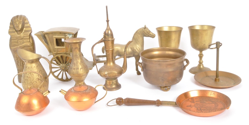 A collection of vintage 20th Century brass items. Including; stem wine cups, horse & cart, heavy decorated mummy, small copper pots and pan, cauldron, vase and a Tibetan style drinking jug. Measures approx.