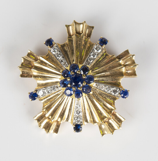 A gold, sapphire and diamond brooch in a cinquefoil shaped design, the centre with a sapphire cluste