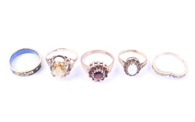 A group of four gold and gem set rings and an enamelled band ring.