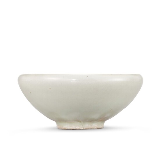 A moulded Yaozhou moon-white glazed 'fish' bowl, Northern Song - Jin dynasty 北宋至金 耀州月白釉印魚紋斂口盌