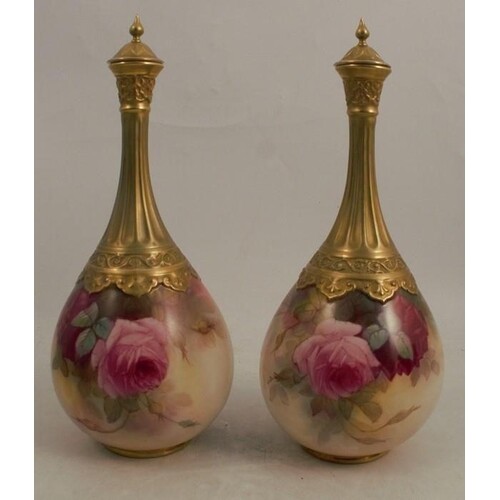 A pair of Royal Worcester covered vases, decorated with rose...
