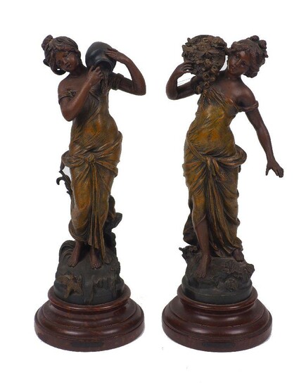 A pair of cold-painted figures, after Moreau, 20th century, spelter on wood plinths, each figure moulded as a woman, one carrying a basket of flowers, the other a water carafe, moulded 'L&F Moreau' to base of figures, with additional plaquettes to...