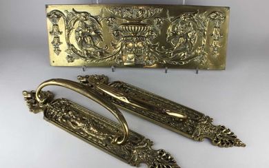 A pair of large brass door handles
