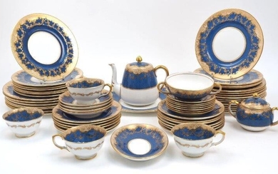 A quantity of Crown Staffordshire tea and dinner wares, 20th century, of blue and cream ground with gilt lattice borders, comprising: seven dinner plates, 27cm diameter, eleven medium plates, 23cm diameter, eleven dessert plates, 21.7cm diameter...