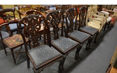 A set of four mahogany dining chairs with carved backs and l...
