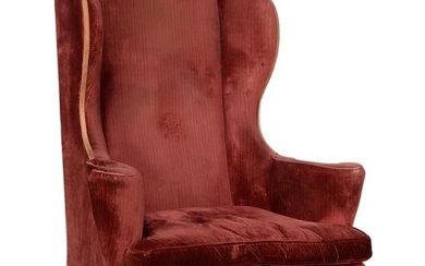 A walnut and upholstered wing armchair in early George III style