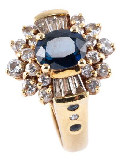 AN 18CT GOLD SAPPHIRE AND DIAMOND CLUSTER RING; centring an approx. 1.1ct dark blue oval sapphire to a surround of 18 round brillian...