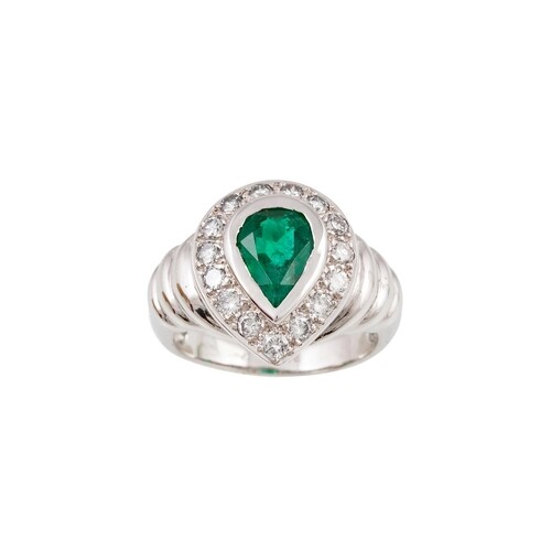 AN EMERALD AND DIAMOND CLUSTER RING, the pear shaped emerald...