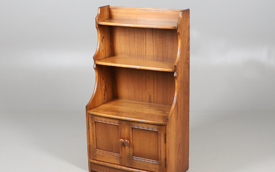 AN ERCOL OPEN FRONT WATERFALL BOOKCASE.