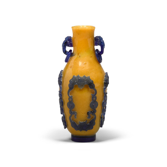An elegant blue overlay yellow glass vase