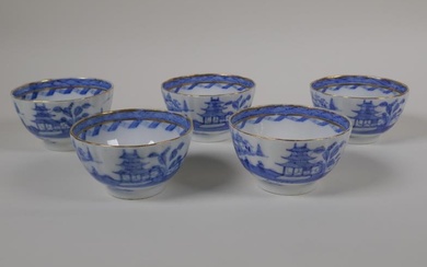 Five blue and white porcelain tea bowls of ribbed...