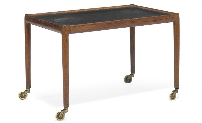Helge Vestergaard Jensen: Brazilian rosewood serving cart with raised edges, top covered with black Formica. Mounted on brass castors.