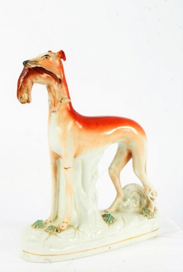 Large Victorian Staffordshire greyhound, modelled with a hare to the mouth, 28cm tall