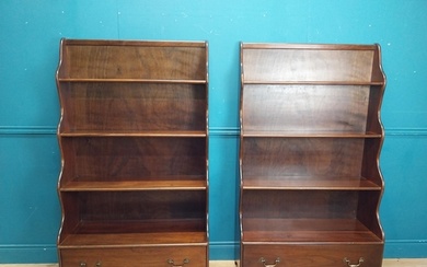 Pair of mahogany open tiered waterfall bookcases with one lo...