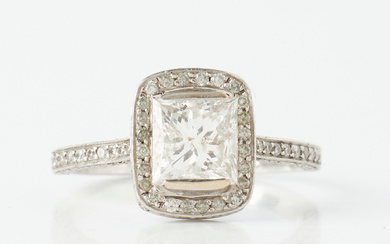 RING, 18 k white gold, 1 princess cut diamond, approx. 1,70 ct, quality TCr-cr (I-J) /I, bordered by and ring rail with decoration of brilliant cut diamonds, total approx. 1,30 ct.