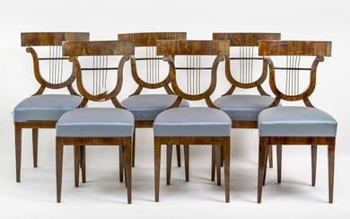 Six Biedermeier chairs. Walnut, on straight conical legs, upholstered seat,...