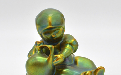 ZSOLNAY PECS PORCELAIN, CHILD WITH JUG, CERAMIC WITH IRIDESCENT EOSIN, HAND PAINTED, AROUND 1920S.
