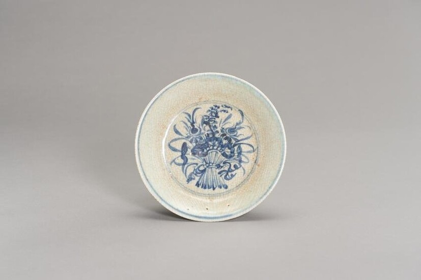 A CELADON AND BLUE DISH WITH A FLOWER BOUQUET