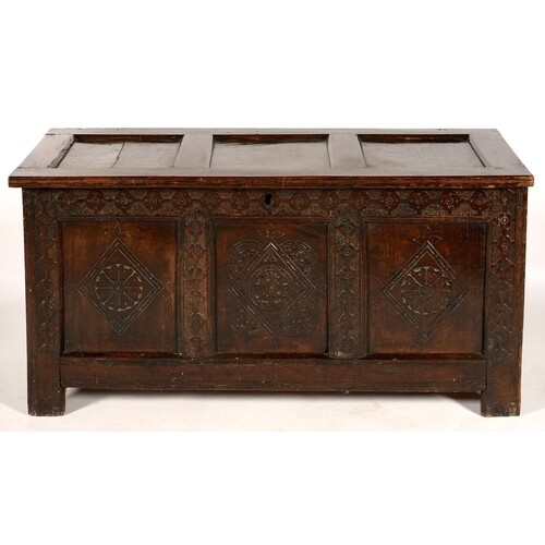 A CHARLES II JOINED OAK CHEST WITH CARVED FRIEZE, STILES AND...