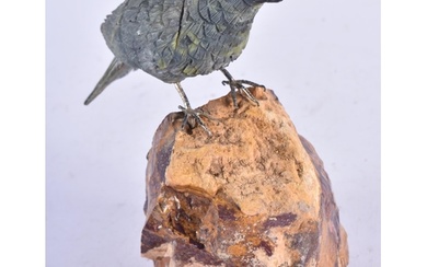 A Carved Hardstone Model of a Bird with Silver Feet Perched ...
