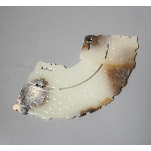 A Chinese archaistic jade fan shaped plaque, the pale celado...