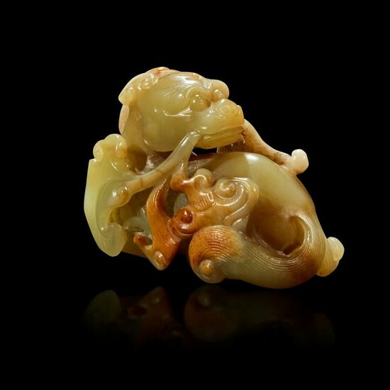 A Chinese small celadon, beige and russet jade figure