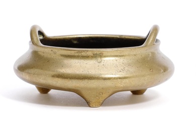 A Chinese tripod bronze censer of compressed globular form with two handles...