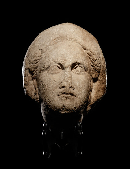 A Cypriot Limestone Head of a Goddess, Perhaps Aphrodite or Demeter