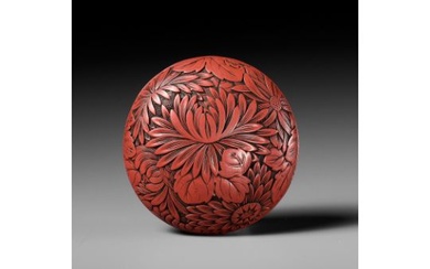 A FINE TSUISHU (CARVED RED LACQUER) MANJU NETSUKE WITH CHRYSANTHEMUMS
