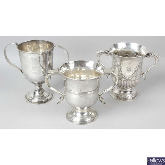 A George III silver twin-handled cup, together with two further examples.