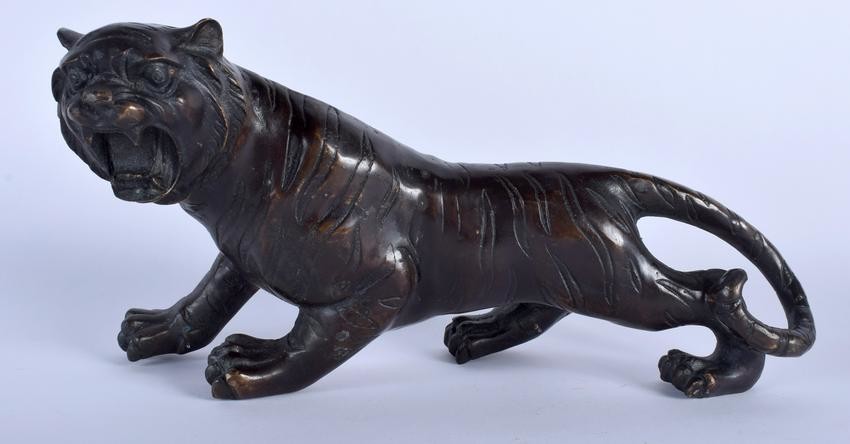 A JAPANESE BRONZE OKIMONO IN THE FORM OF A TIGER