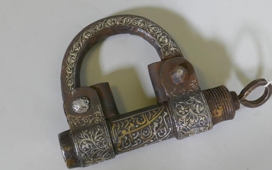 A Middle Eastern cast iron padlock with raised decoration...
