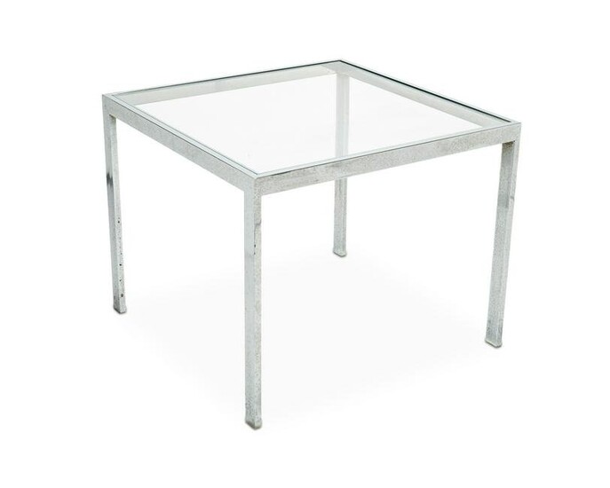 A Milo Baughman-style chrome and glass end table