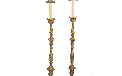 A PAIR OF ITALIAN CARVED AND GILTWOOD ALTAR CANDLESTICKS FIRST...