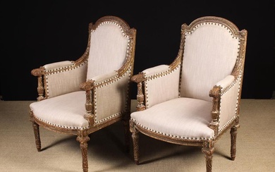 A Pair of Louis XVI Style Armchairs. The upholstered backs, sides and sprung seats covered in ecru c