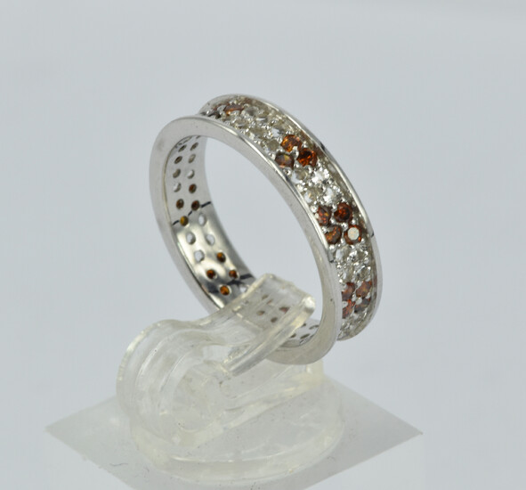 A RED DIAMOND AND TOPAZ INFINITY RING