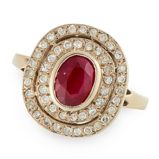 A RUBY AND DIAMOND CLUSTER RING set with an oval cut