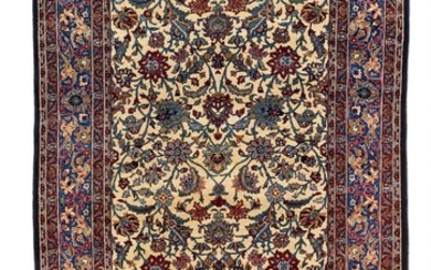 A Tehran rug, Persia. All over design of linked palmettes and flower heads on an ivory field executed in colorful lustrous wool. First half 20th century.