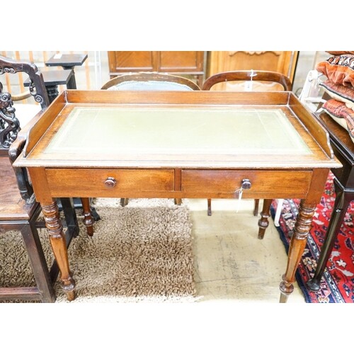 A Victorian mahogany two drawer writing table, length 106cm,...