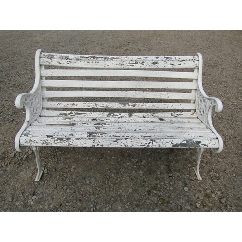 A Victorian style garden bench , the cast iron ends with fol...