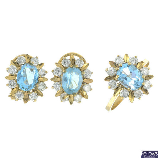 A blue topaz and diamond cluster ring and earring set.