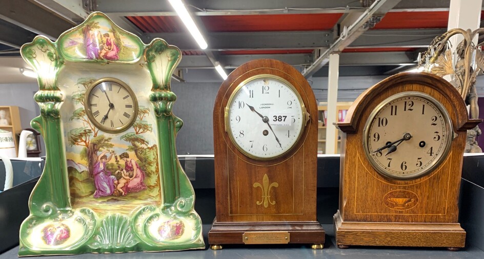 A brass inlaid mahogany Benson mantle clock, H. 33cm. together with an inlaid oak clock and a Victorian porcelain clock.