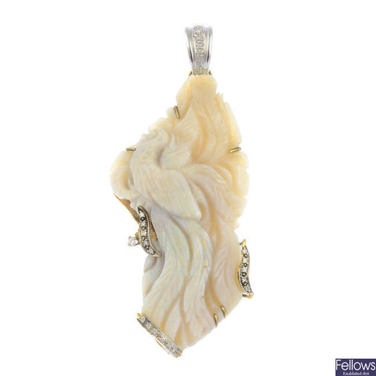 A carved opal pendant, with brilliant-cut diamond highlights.