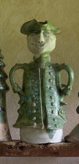 A finial showing a man in a frock...