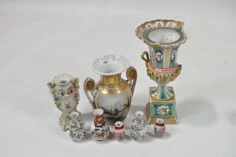 A group of porcelain vases including a gilt two-handled example painted with two landscape scenes
