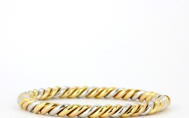 A heavy 18ct yellow and white gold twist design bangle, internal L. 6cm.